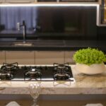 A stylish kitchen featuring a gas stove, marble top, and indoor plants. Perfect for home interior inspiration.